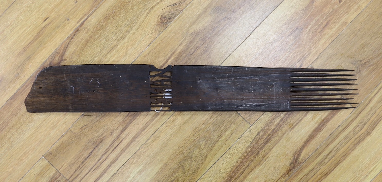 An African carved hardwood comb, Swahili, 83 cms long.